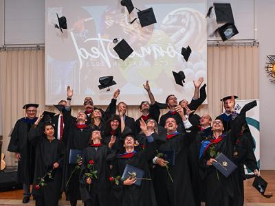 The Korntal graduates celebrate while flanked by CIU Interim President Dr. Rick Christman and Provost Dr. James Lanpher. 